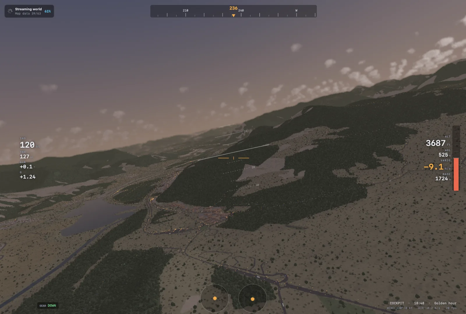 Dusk flight along a forested mountain flank above a valley with a lake and town lights